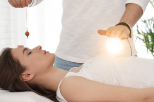 A skilled Reiki and energy healer in Melbourne performing a healing session at Bliss Healing Center.